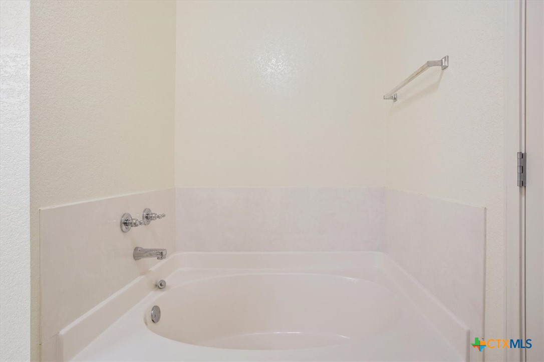 2817 North 12th Street Temple, TX 76501 - Photo 16 of 23 a close up of a bathtub in a bathroom