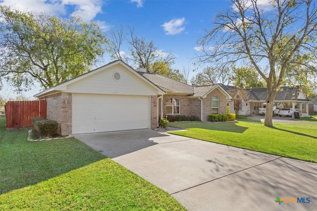 2817 North 12th Street Temple, TX 76501 - Photo 2 of 23 a front view of a house with a yard and garage
