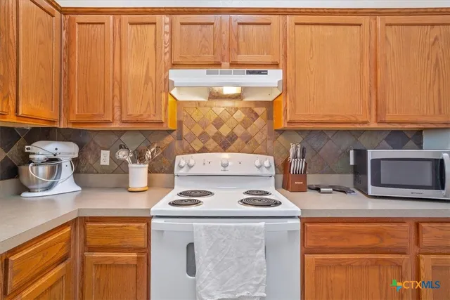 a kitchen with a refrigerator a stove a sink and dishwasher