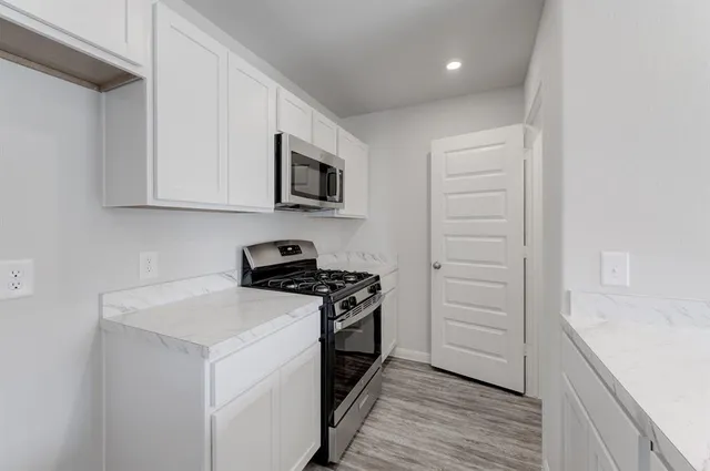 a kitchen with a sink stove and cabinets