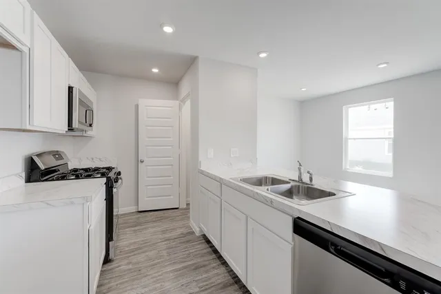 a kitchen with a sink and cabinets