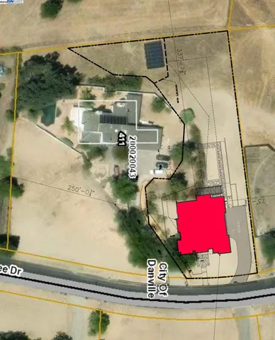 an aerial view of a residential houses with yard