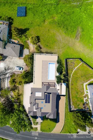 an aerial view of a residential houses with outdoor space