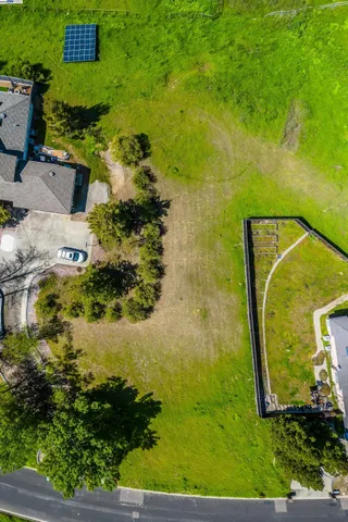 an aerial view of a house with a yard basket ball court and outdoor seating