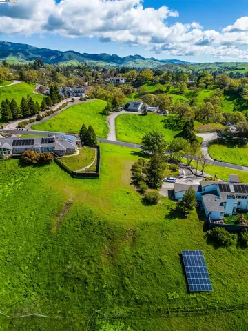 an aerial view of a house with a garden and swimming pool