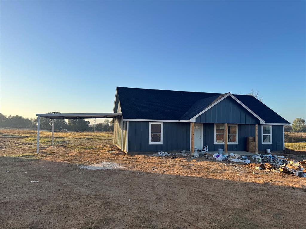 a front view of a house with a yard and lake view