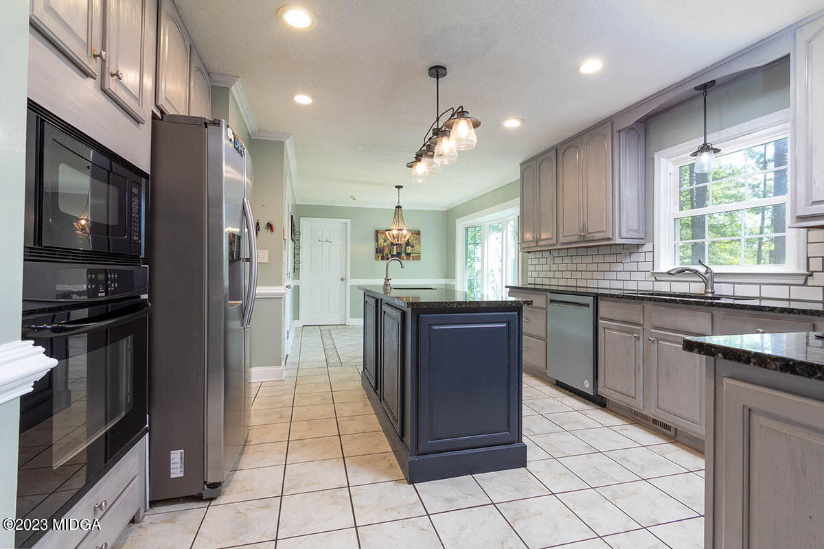 173 Old Ridge Road Macon, GA 31211 - Photo 13 of 37 a kitchen with stainless steel appliances granite countertop a stove a sink and a refrigerator