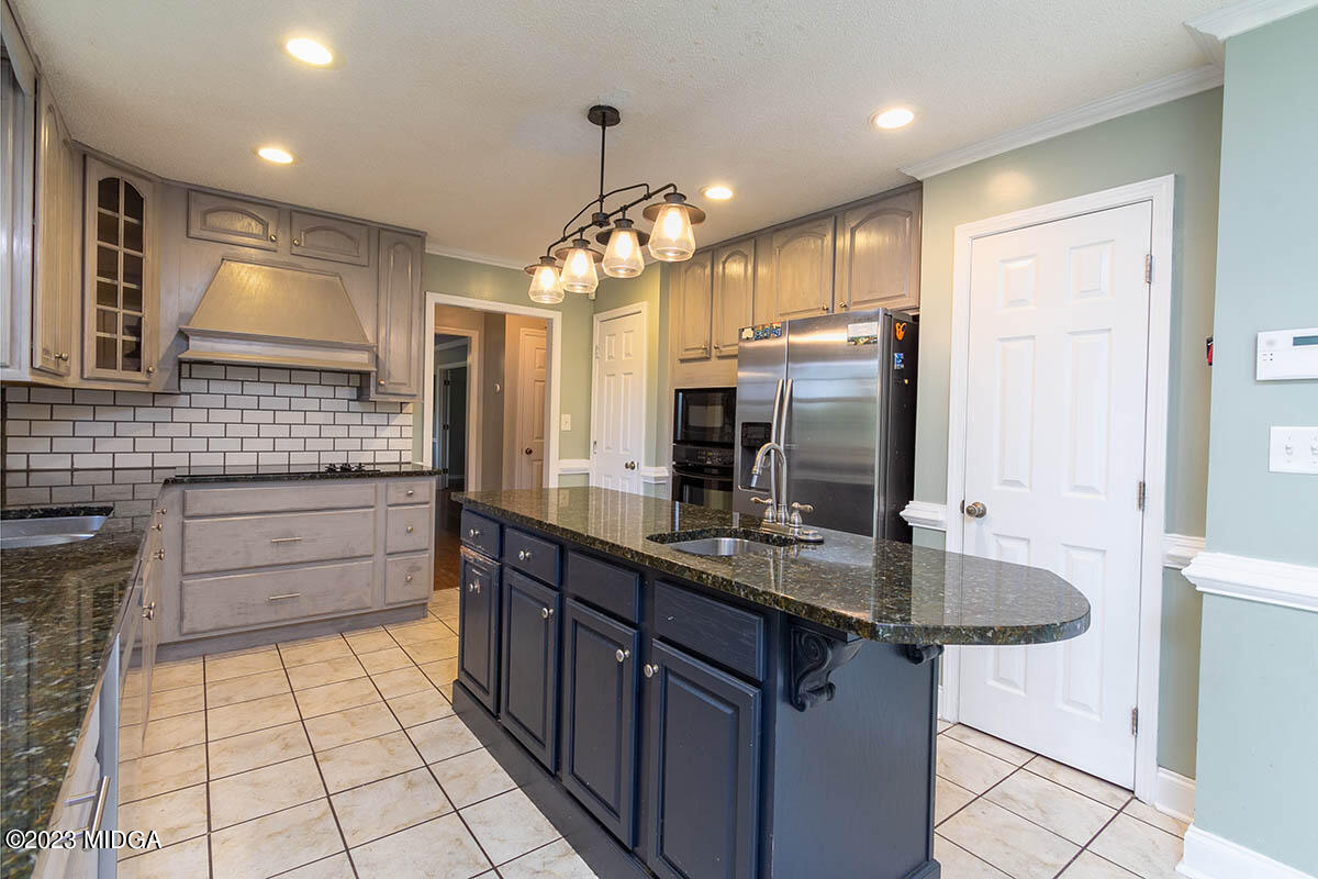 173 Old Ridge Road Macon, GA 31211 - Photo 15 of 37 a bathroom with a sink a large mirror and a shower