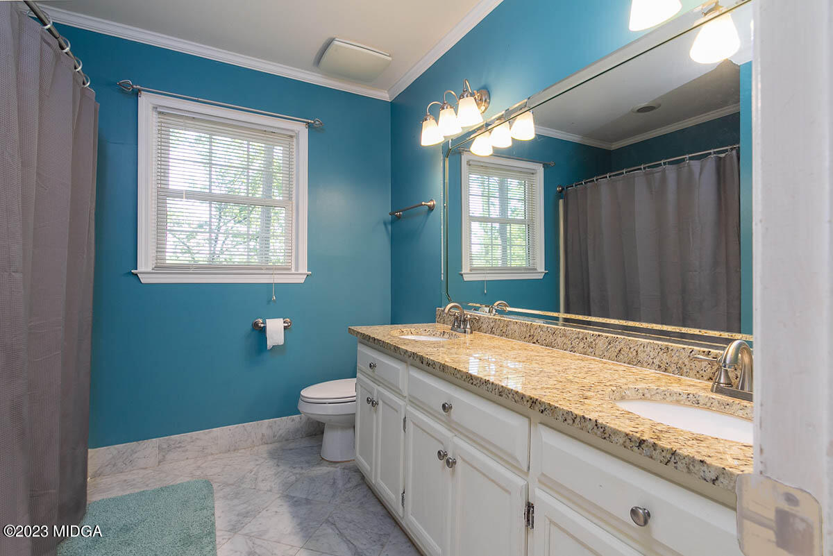 173 Old Ridge Road Macon, GA 31211 - Photo 20 of 37 a bathroom with a granite countertop sink toilet and mirror