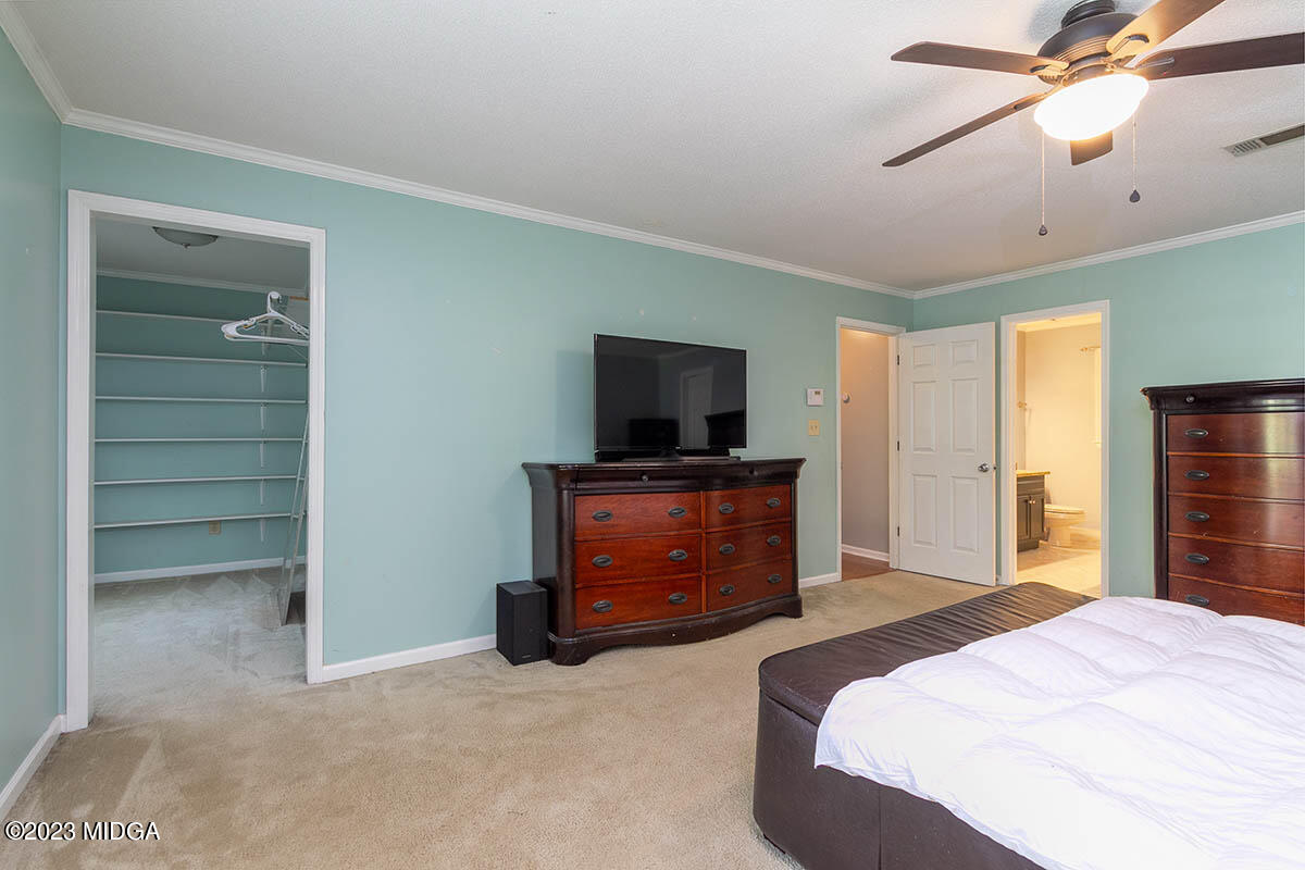 173 Old Ridge Road Macon, GA 31211 - Photo 22 of 37 a bedroom with a bed and a flat tv screen on dresser