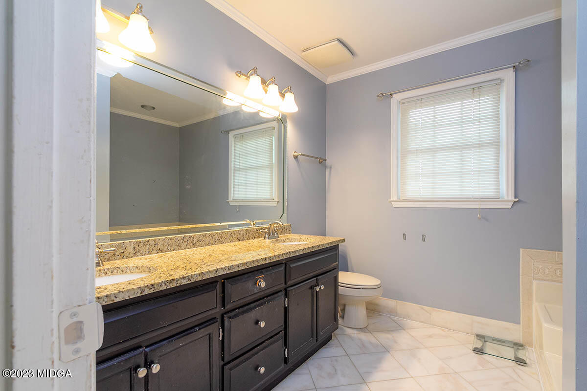 173 Old Ridge Road Macon, GA 31211 - Photo 24 of 37 a bathroom with a granite countertop sink toilet and mirror