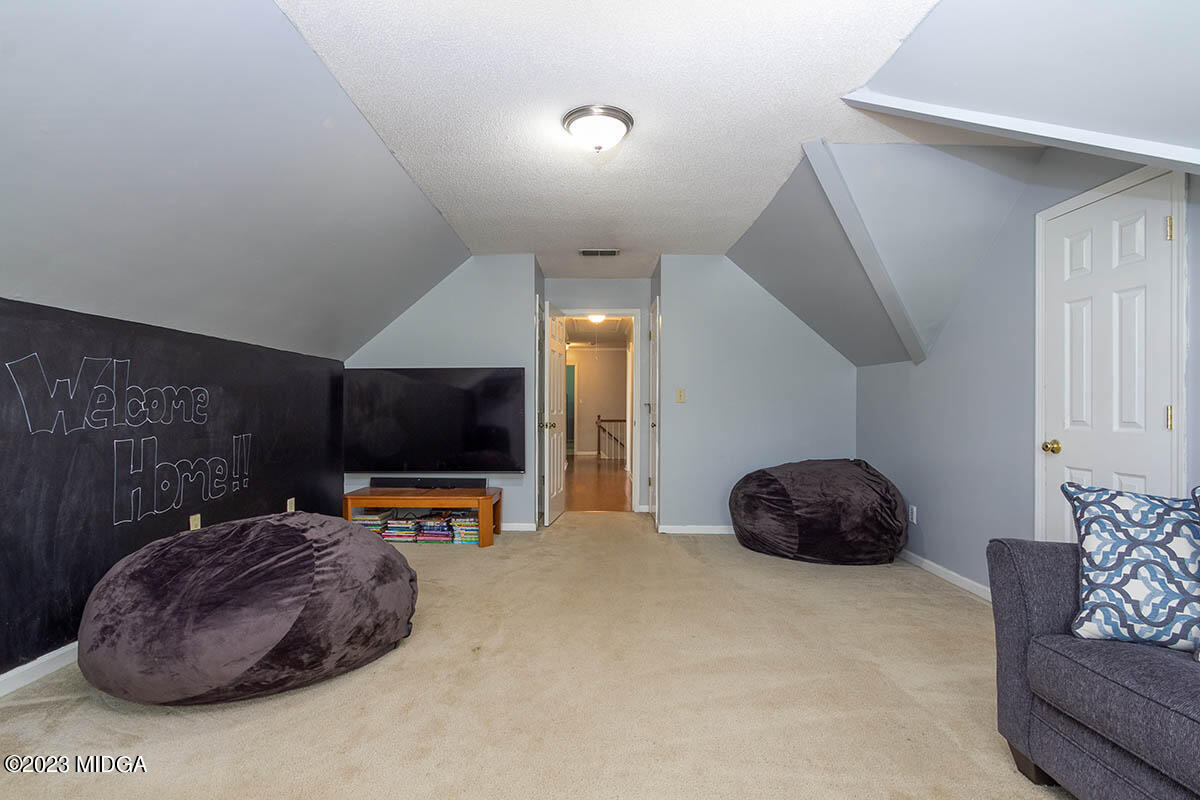173 Old Ridge Road Macon, GA 31211 - Photo 28 of 37 a living room with furniture and a flat screen tv