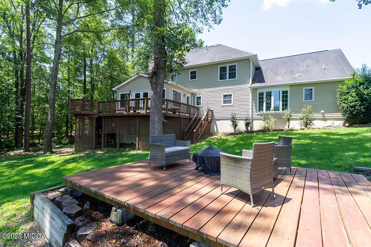 173 Old Ridge Road Macon, GA 31211 - Photo 32 of 37 a view of a patio with table and chairs potted plants and a large tree