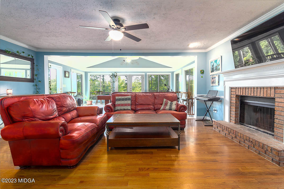 173 Old Ridge Road Macon, GA 31211 - Photo 6 of 37 a living room with furniture a fireplace and a large window