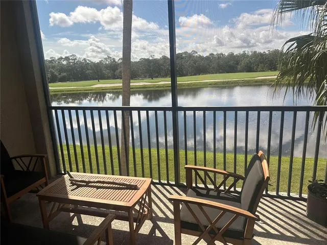 a view of a balcony with lake view and sitting space