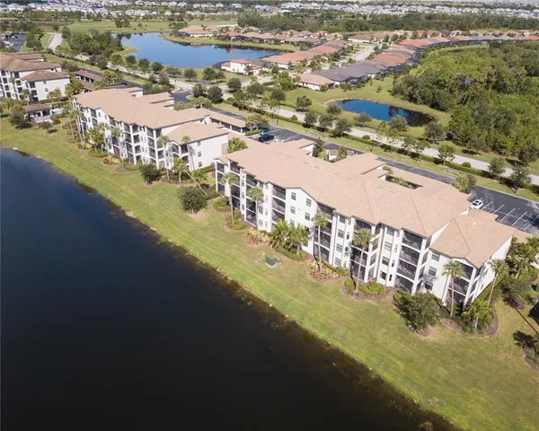 a living room with furniture a fireplace and windows