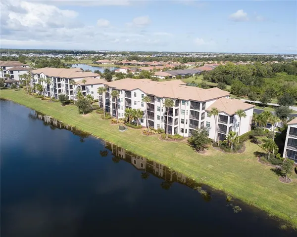 a large white kitchen with a sink and dishwasher with a large kitchen island