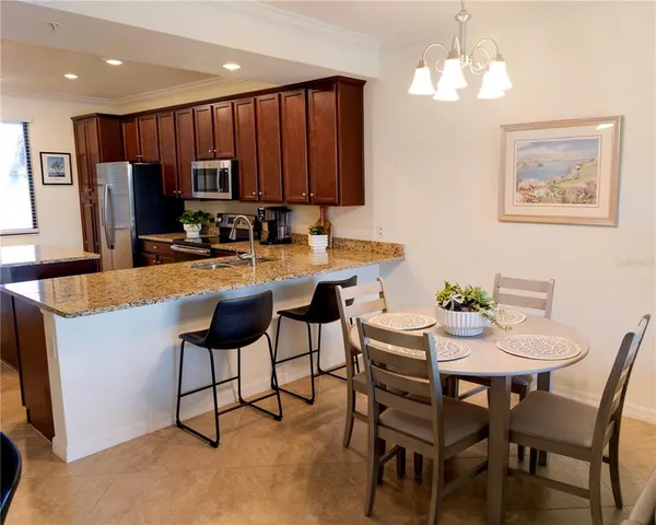 a living room with furniture kitchen view and a flat screen tv
