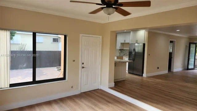 a kitchen with stainless steel appliances granite countertop a refrigerator and a stove