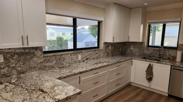 a kitchen with granite countertop white cabinets and a granite counter tops
