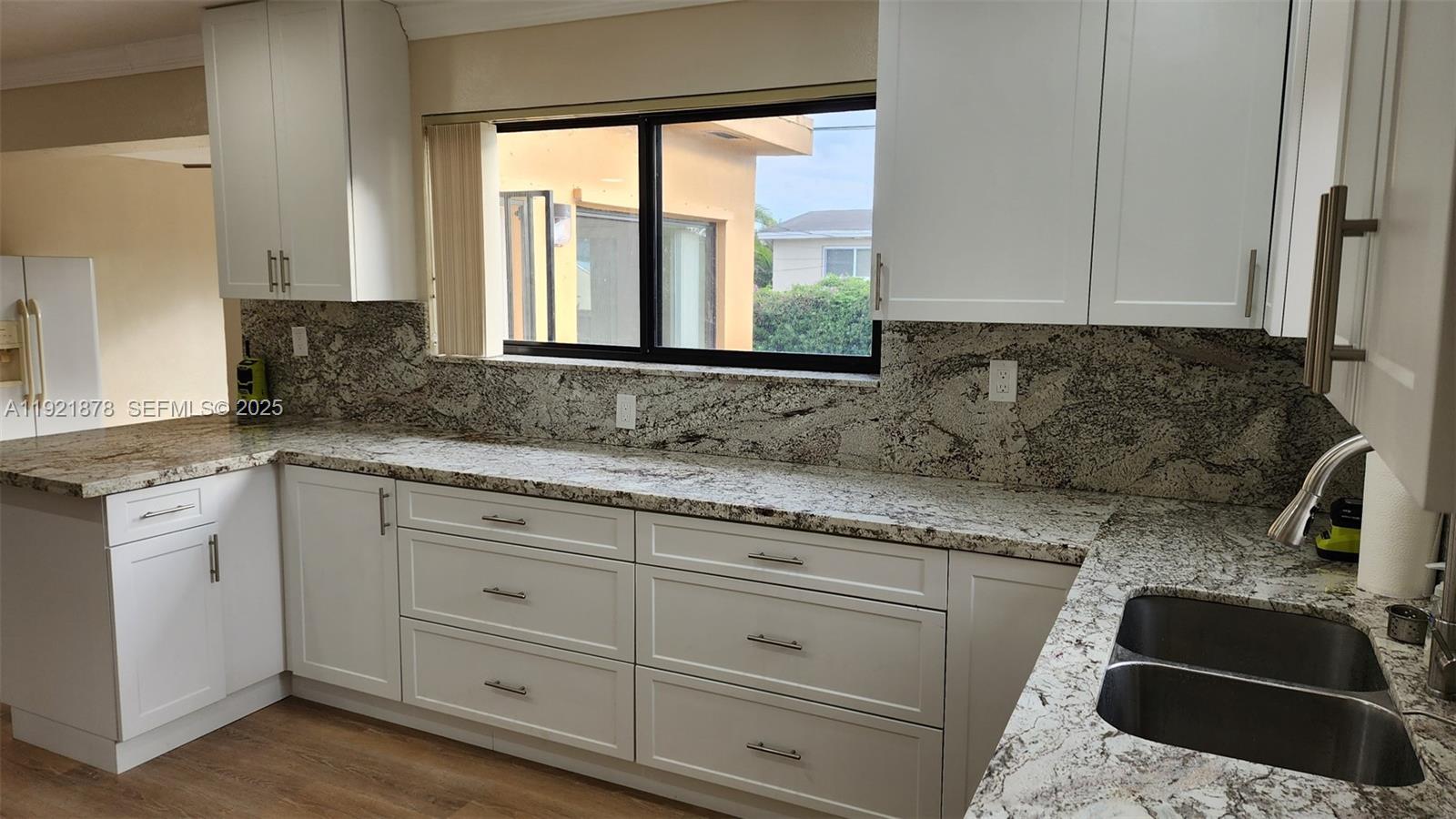 8010 Southwest 16th Street, Unit 8010 Miami, FL 33155 - Photo 18 of 33 a kitchen with granite countertop white cabinets and a granite counter tops