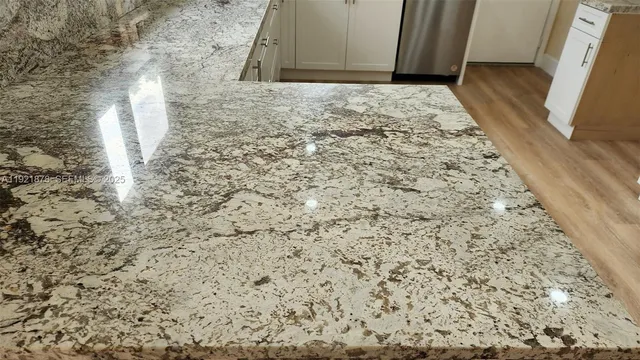 a bathroom with a glass shower door and a chandelier fan