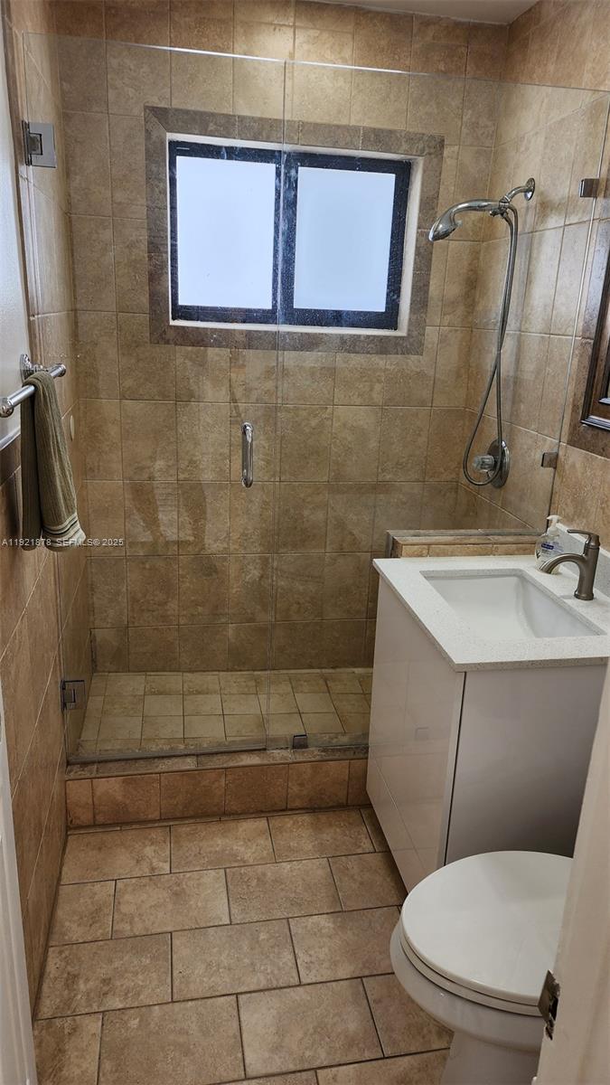 8010 Southwest 16th Street, Unit 8010 Miami, FL 33155 - Photo 23 of 33 a bathroom with a toilet a sink and mirror