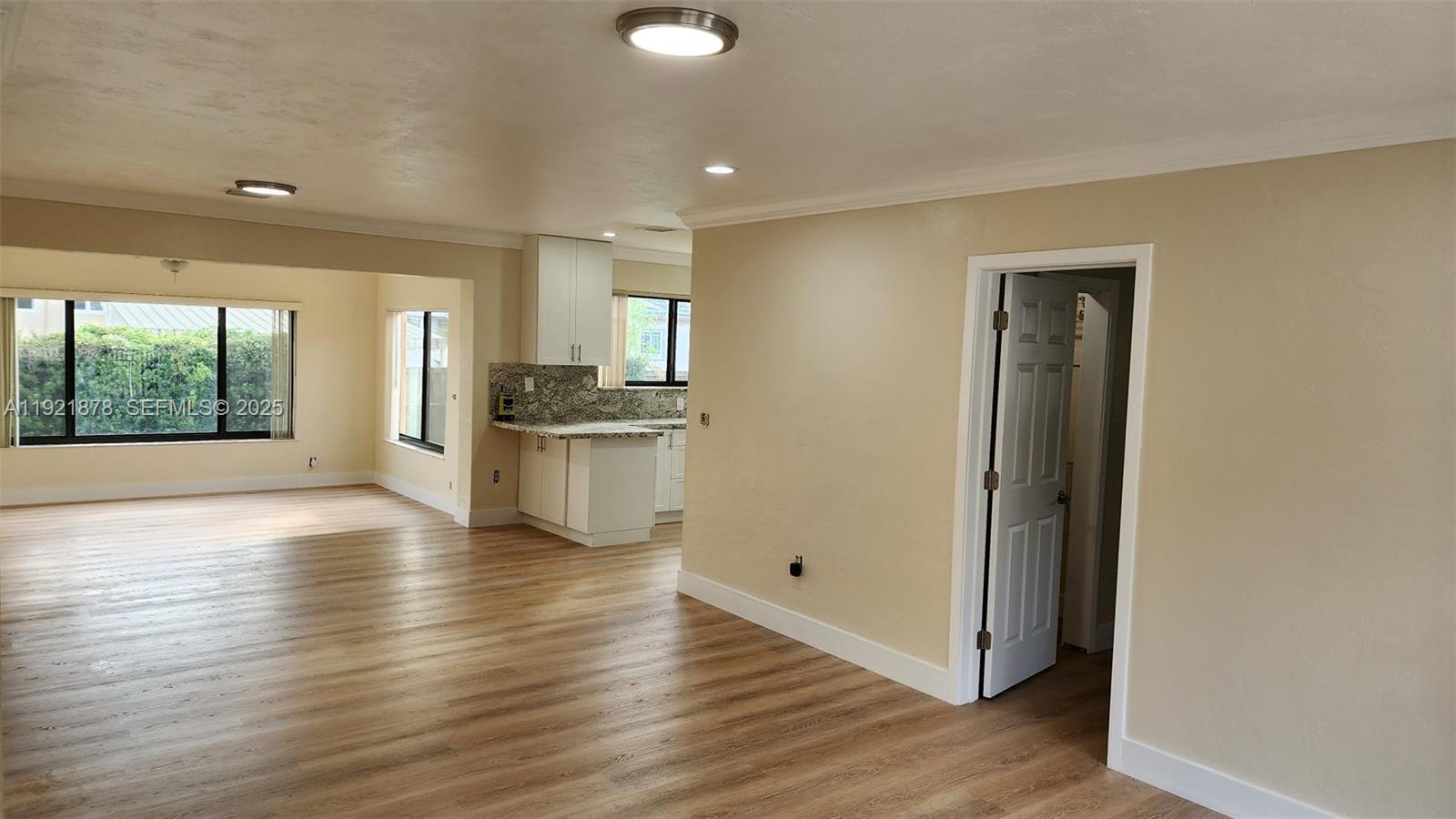 8010 Southwest 16th Street, Unit 8010 Miami, FL 33155 - Photo 10 of 33 an empty room with wooden floor and windows