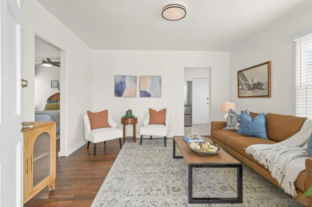 a living room with furniture and wooden floor