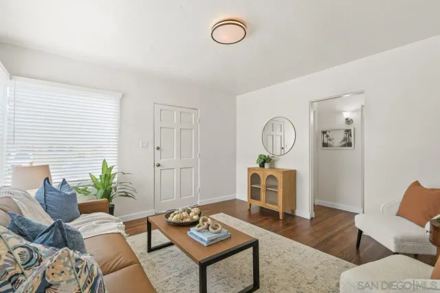 a living room with furniture a rug and a window