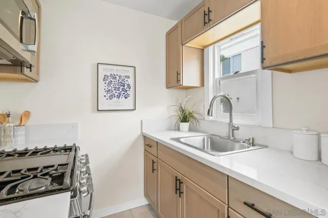 a kitchen with a sink and a stove top oven