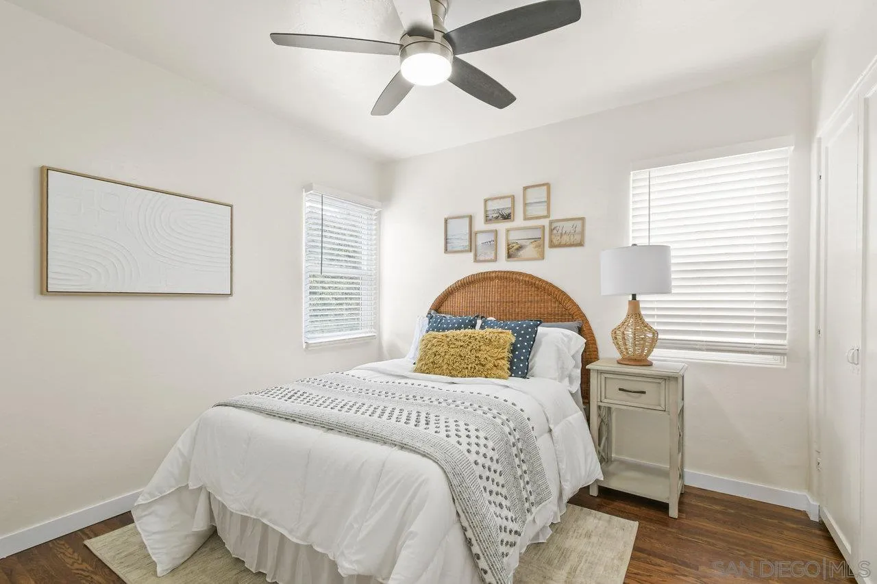 4614-4616 Larkspur Street San Diego, CA 92107 - Photo 22 of 51 a bedroom with a bed and a chandelier