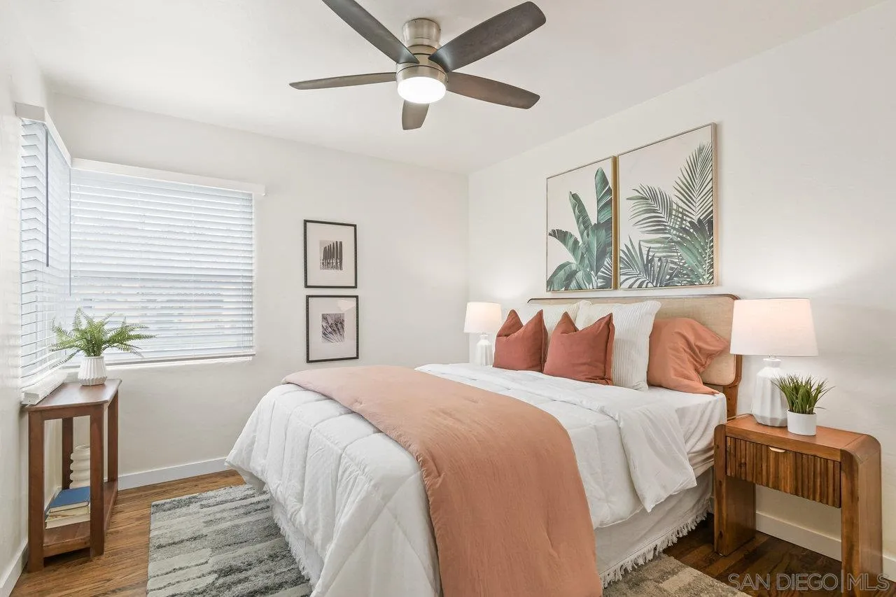 4614-4616 Larkspur Street San Diego, CA 92107 - Photo 23 of 51 a bedroom with a large bed and a chandelier