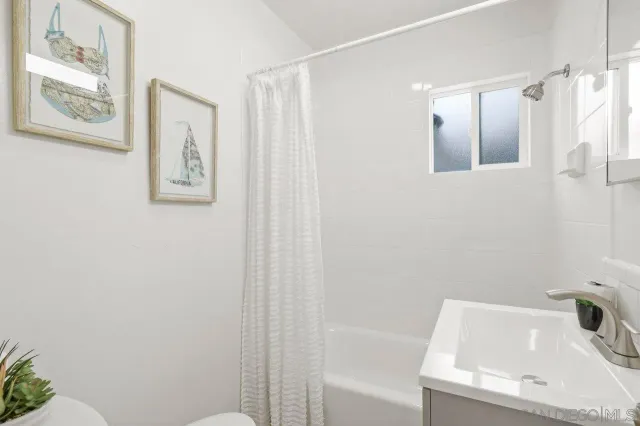 a bathroom with a bathtub and shower