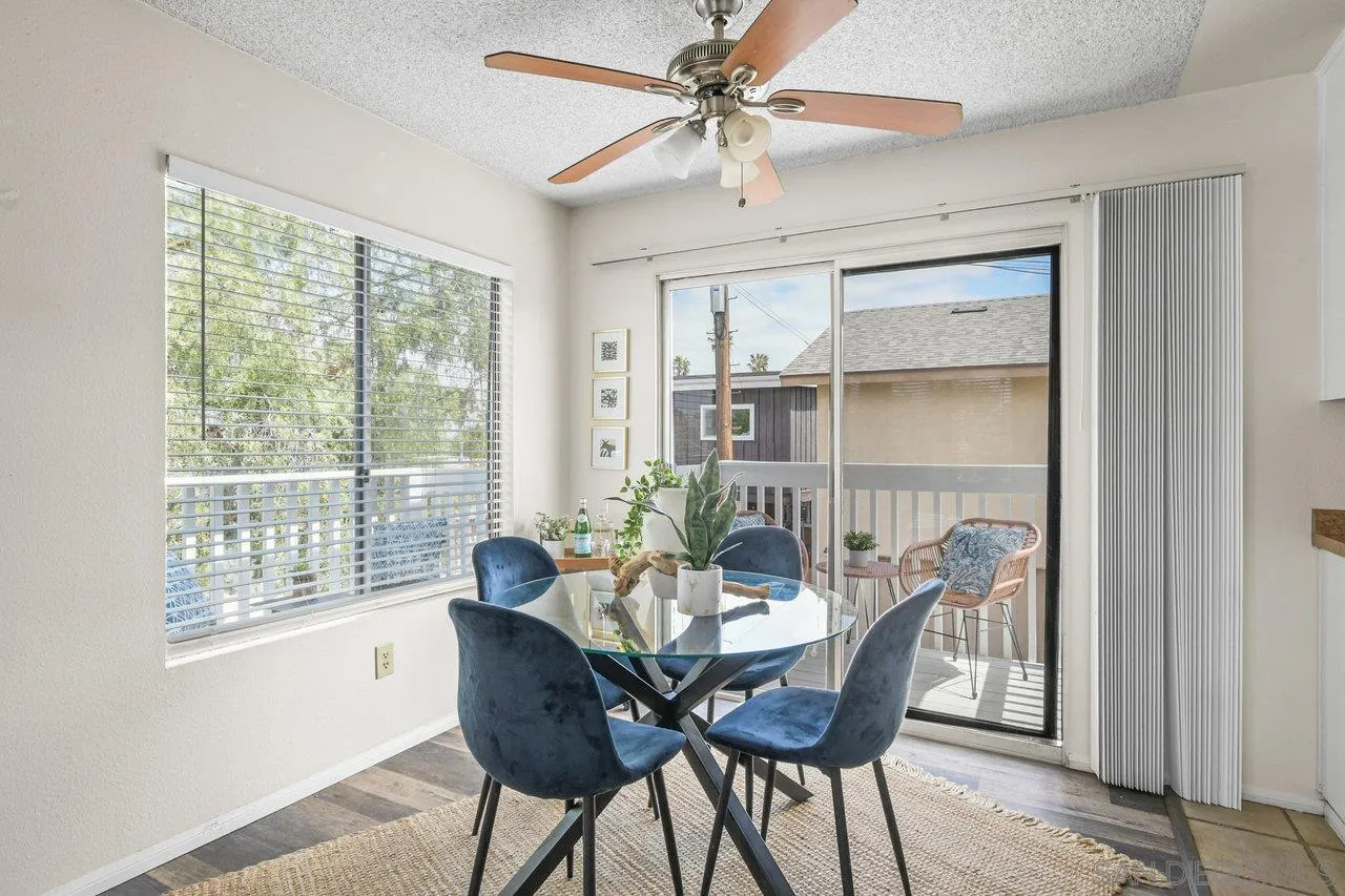 4614-4616 Larkspur Street San Diego, CA 92107 - Photo 30 of 51 a dining room with furniture a chandelier and wooden floor
