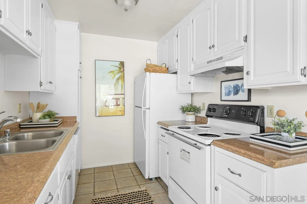 4614-4616 Larkspur Street San Diego, CA 92107 - Photo 34 of 51 a kitchen with stainless steel appliances granite countertop a sink stove and refrigerator