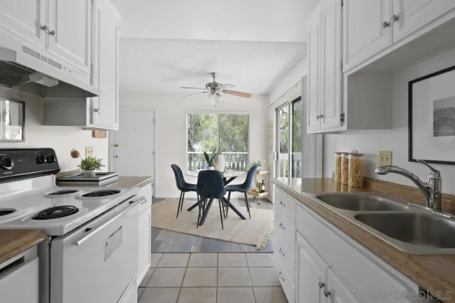 a bathroom with a granite countertop sink toilet mirror and shower