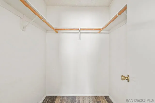 a bathroom with a granite countertop toilet a sink and mirror
