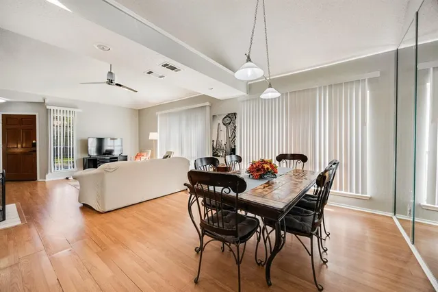 a view of a dining room with furniture window and wooden floor