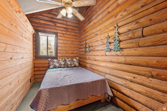 4725 Pine Ridge Road Evanston, UT 82930 - Photo 40 of 82 Natural wood walls featuring log construction and shiplap paneling