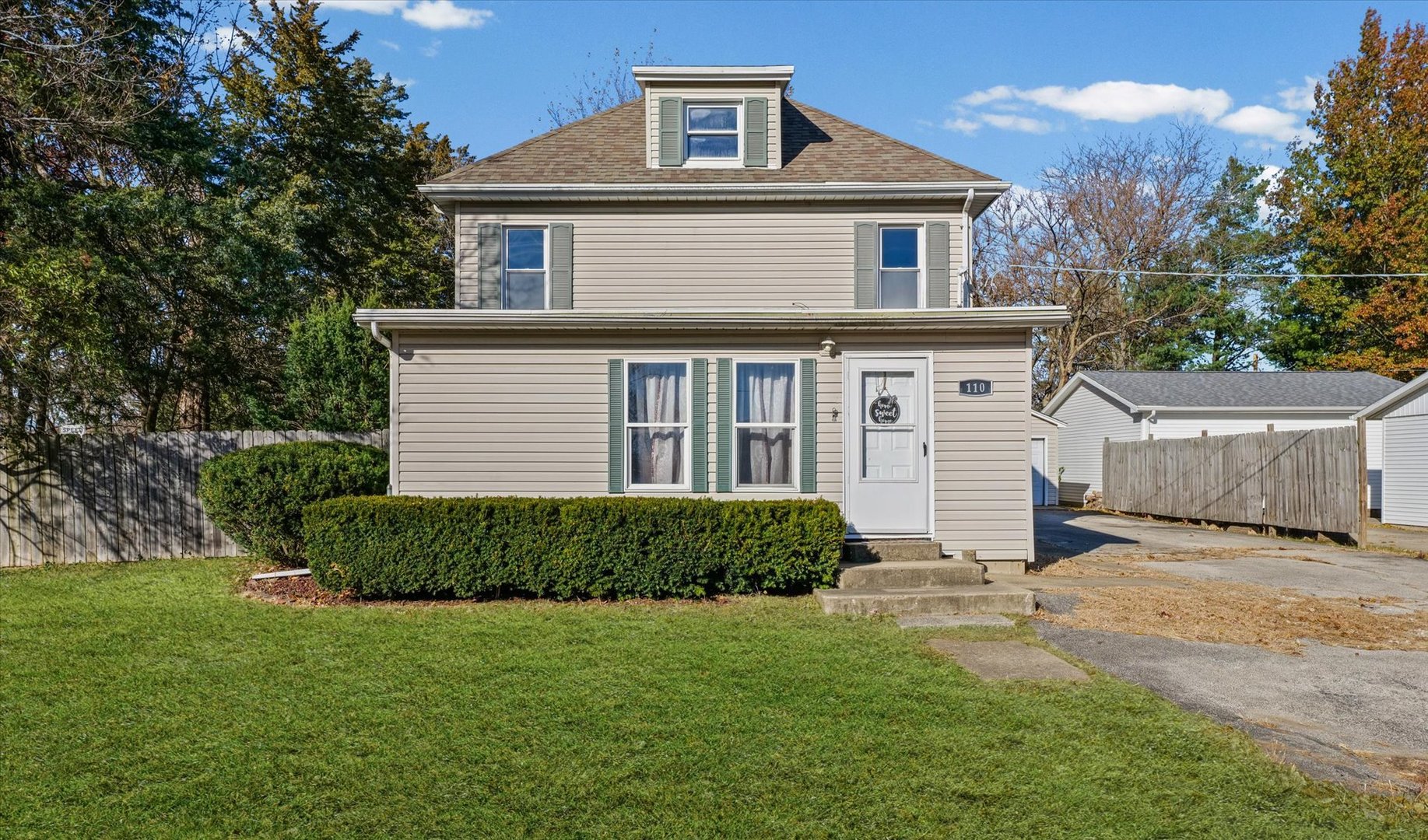 a front view of a house with a garden