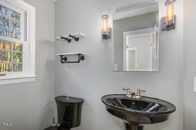 2903 Tavistock Drive Durham, NC 27712 - Photo 12 of 28 a bathroom with a sink and a mirror