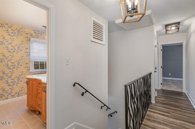 2903 Tavistock Drive Durham, NC 27712 - Photo 15 of 28 a view of a hallway with wooden floor and staircase