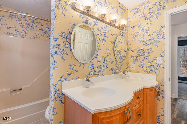 2903 Tavistock Drive Durham, NC 27712 - Photo 22 of 28 a bathroom with a sink and a mirror