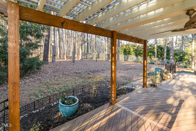 2903 Tavistock Drive Durham, NC 27712 - Photo 24 of 28 a view of a porch with a dining table and chairs