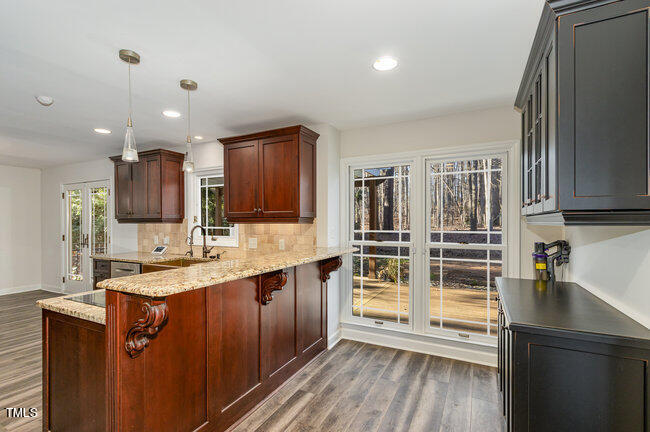 2903 Tavistock Drive Durham, NC 27712 - Photo 7 of 28 a kitchen with wooden cabinets and sink