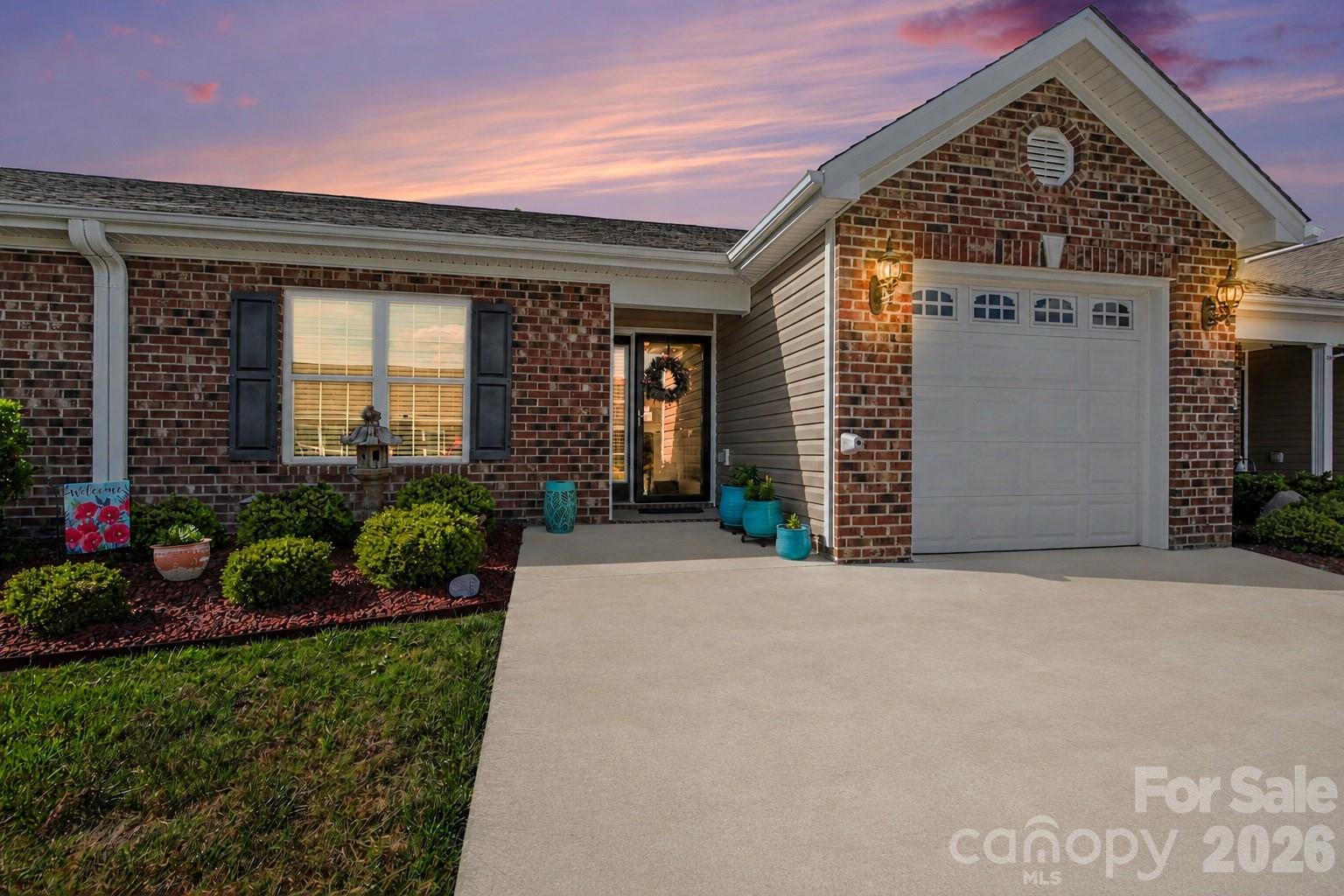 105 Oak Ridge Drive Archdale, NC 27263 - Photo 2 of 21 a front view of a house with a yard and potted plants