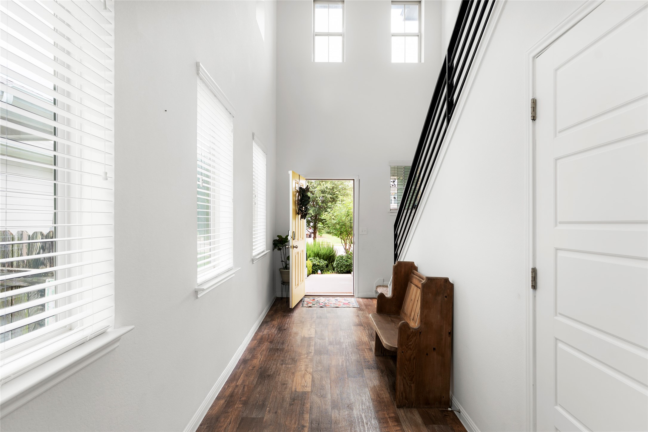 249 Wapiti Road Buda, TX 78610 - Photo 3 of 21 A welcoming entryway with soaring ceilings and rich hardwood flooring sets a bright, inviting tone.
