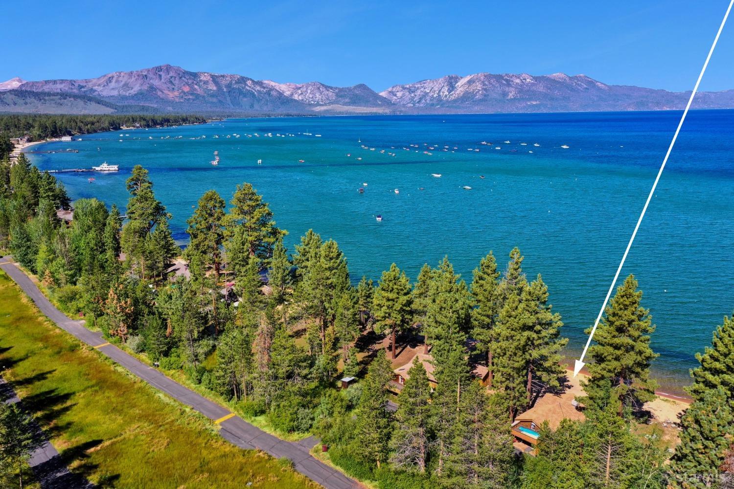 3865 Beach Road South Lake Tahoe, CA 96150 - Photo 2 of 35 a view of a lake with a mountain