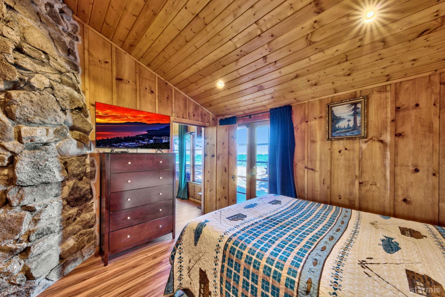 3865 Beach Road South Lake Tahoe, CA 96150 - Photo 21 of 35 a bedroom with a bed and a tv